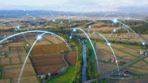 Image shows representation of data signals traveling to different points over farmland