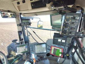 Picture of multiple computers in the cab of a tractor that are used in precision agriculture